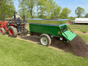 320 MS spreading topsoil on a garden from earth and turf