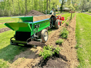 320 Vineyard spreader spreading mulch onto rows