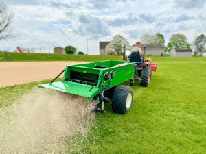 320 spreaders spreading sand for lawn leveling from earth and turf