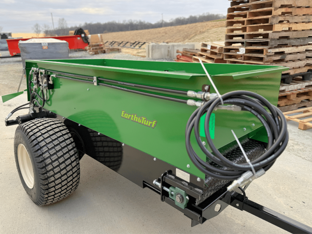 320 topdressing spreader sitting on a driveway from earth and turf