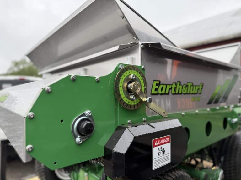 Adjustable end gate on the 415 Multispread stand on topdresser