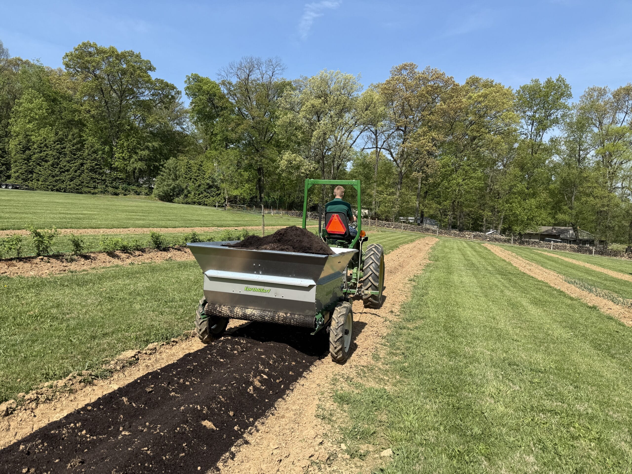 Multispread 248PT being pulled through a garden scaled