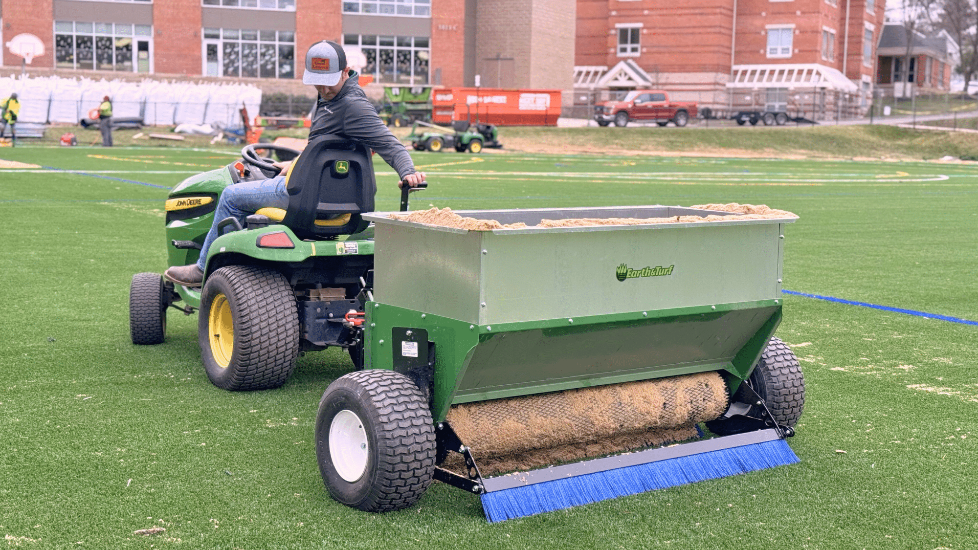 man spreading sand on a 54D spreader